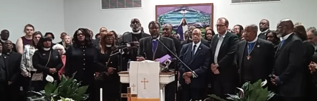 Clay County Bishop Marvin C. Zanders II speaks at a podium during a news conference about a School Board member's racial comments.