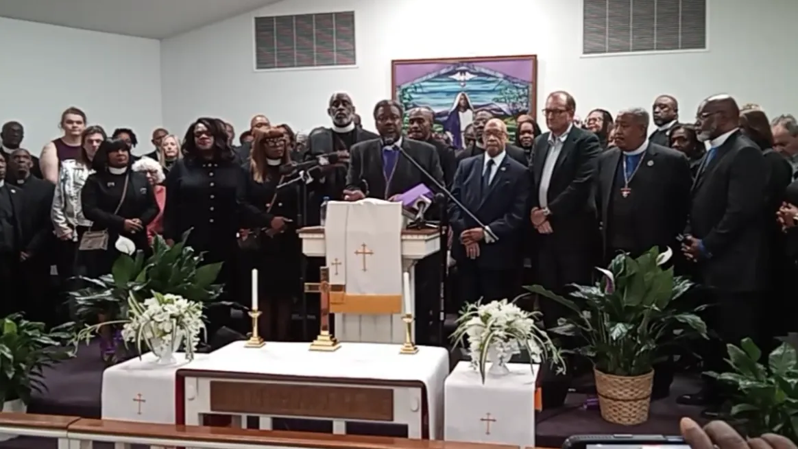 Clay County Bishop Marvin C. Zanders II speaks at a podium during a news conference about a School Board member's racial comments.