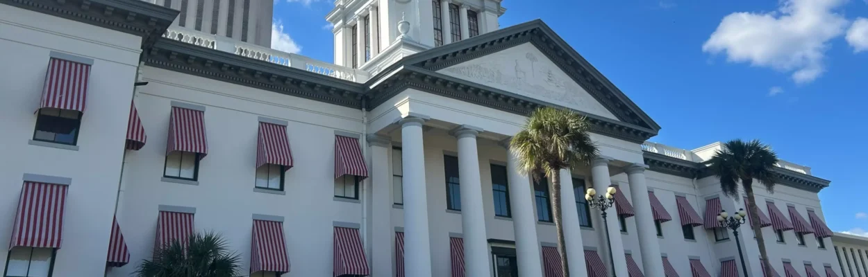 A picture of the Florida Old Capitol with the tower of the new Capitol rising in the background.