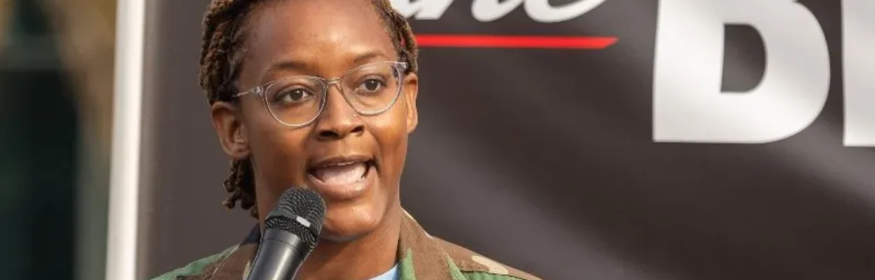 State Rep. Angie Nixon speaks with a microphone.