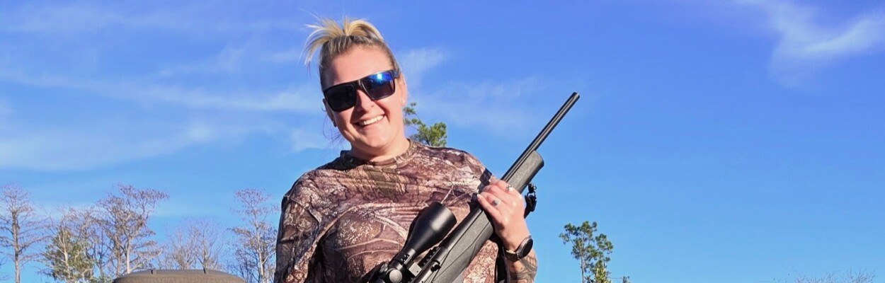 Bear hunter Ashlyn Cross holding her gun.