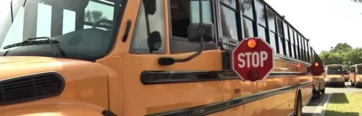 A school bus with its stop sign out to enforce school bus safety.