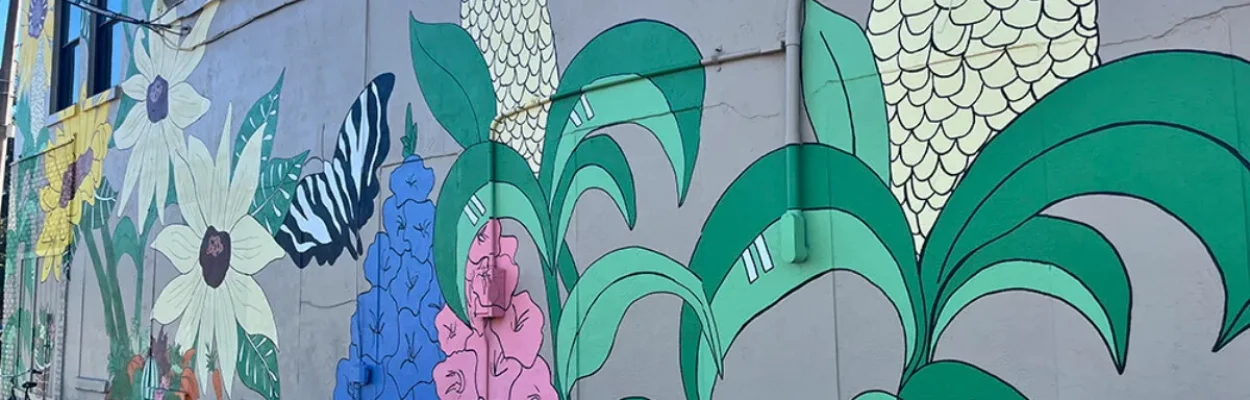 An agriculture-themed mural adorns the side of a building along Hastings' historic Main Street.