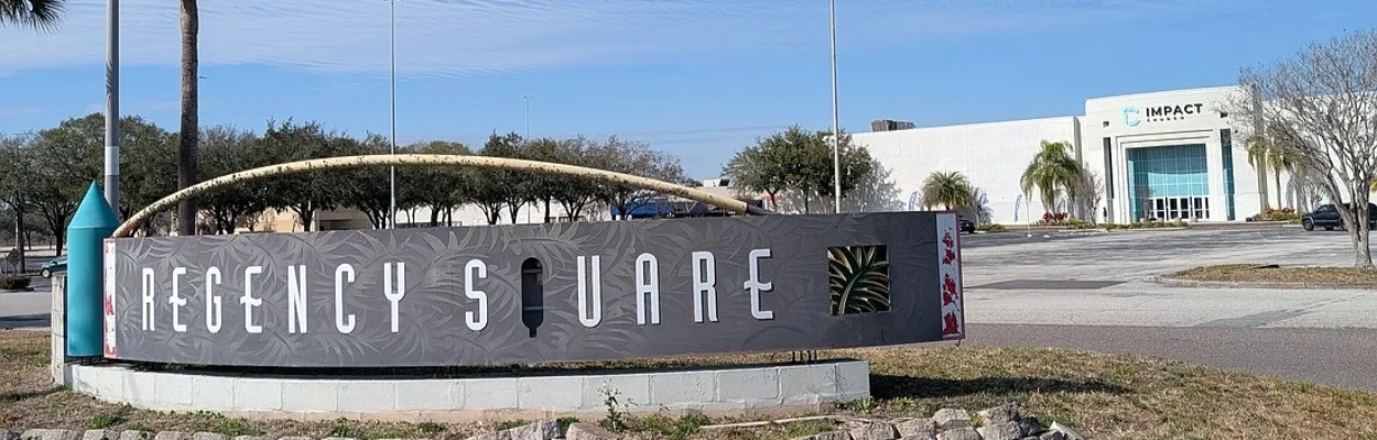 The Regency Square mall sign with the Impact Chrucy building in the background