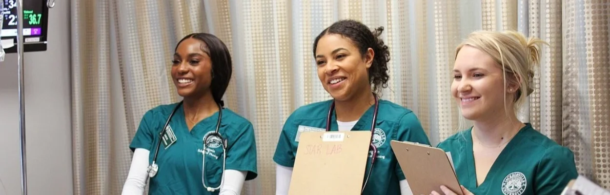 Three nursing students in scrubs