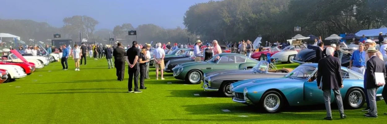 Crowds look over cars on the field at the Amelia Concours show.