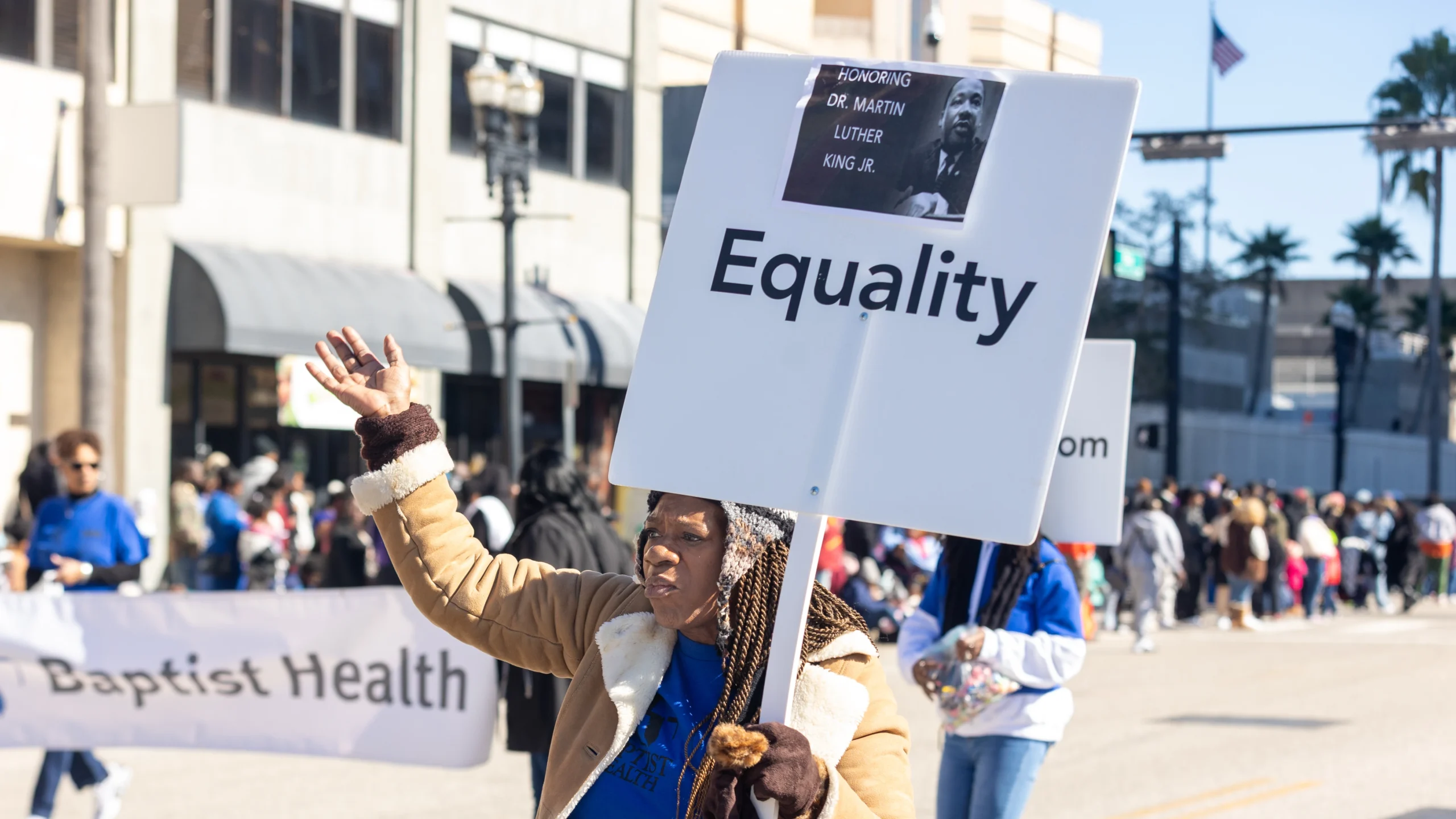 Debra Joshua shares a DEI sentiment while participating in the Martin Luther King Jr. Grand Parade.