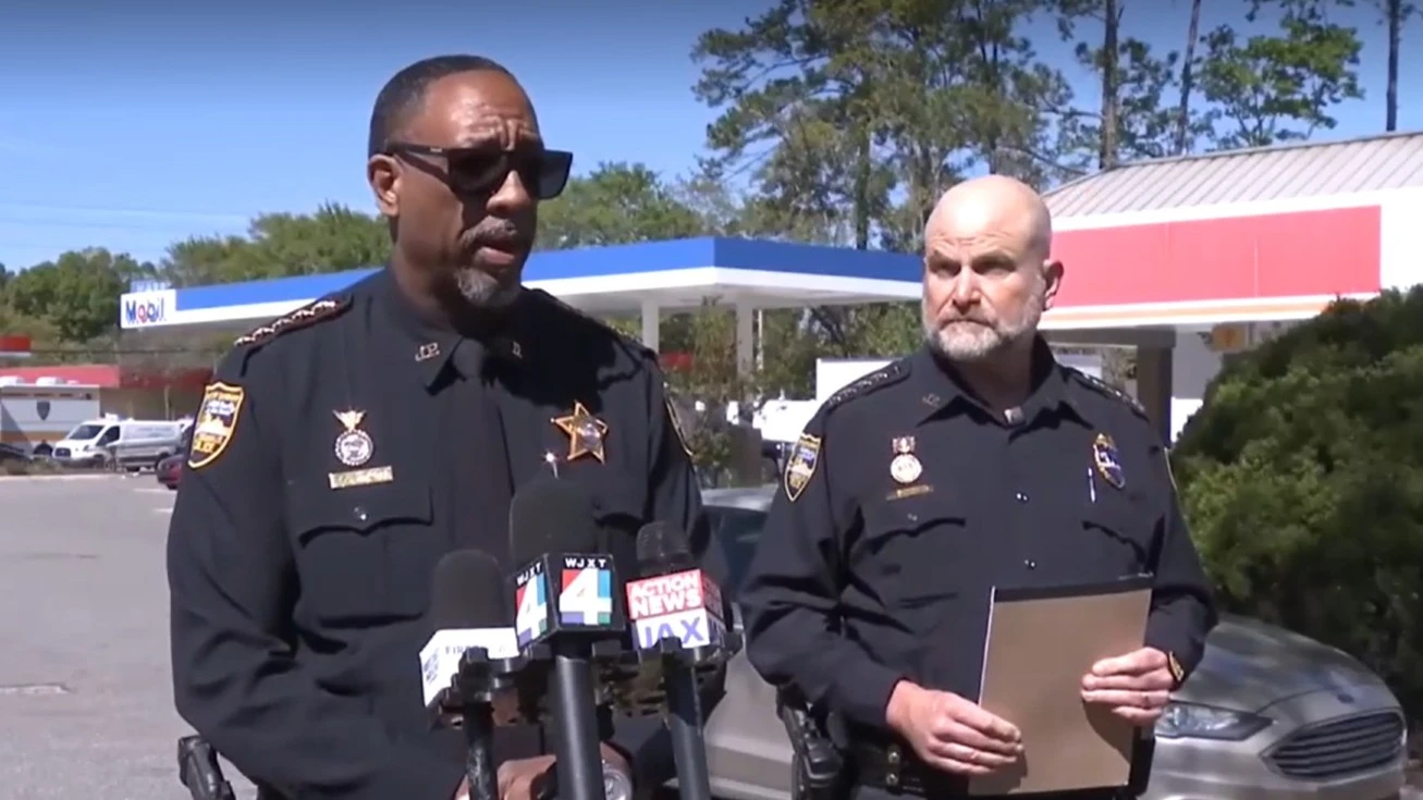 Sheriff T.K. Waters and Undersheriff Shawn Coarsey on the street, where police shot a man with a gun.
