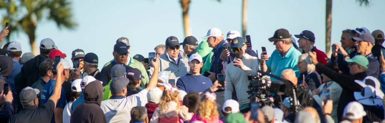 Golfer Rory McIlroy surrounded by sports fans.