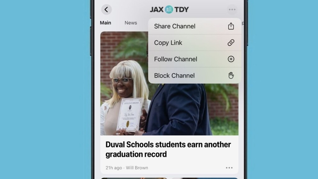 Screenshot of an iPhone showing the 'JaxToday' channel with a menu open listing Share Channel, Copy Link, Follow Channel and Block Channel above a story titled 'Duval Schools students earn another graduation record.'