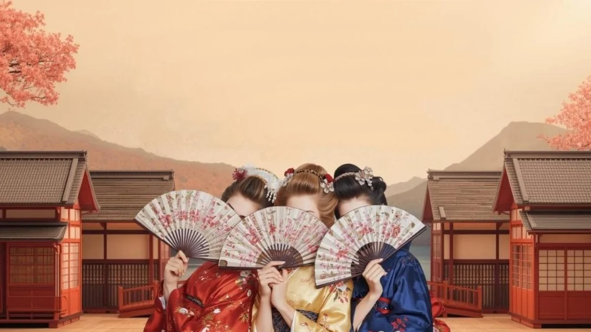 Three performers in The Mikado hold fans over their faces