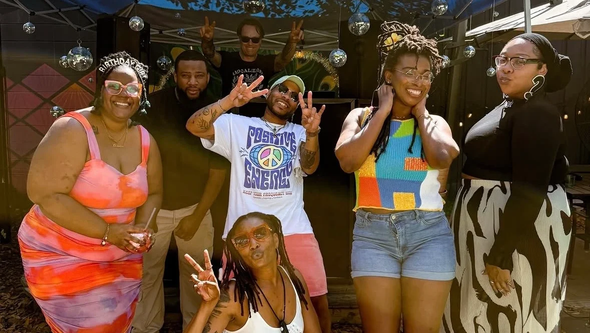 A group of friends smiles at Singalong Brunch