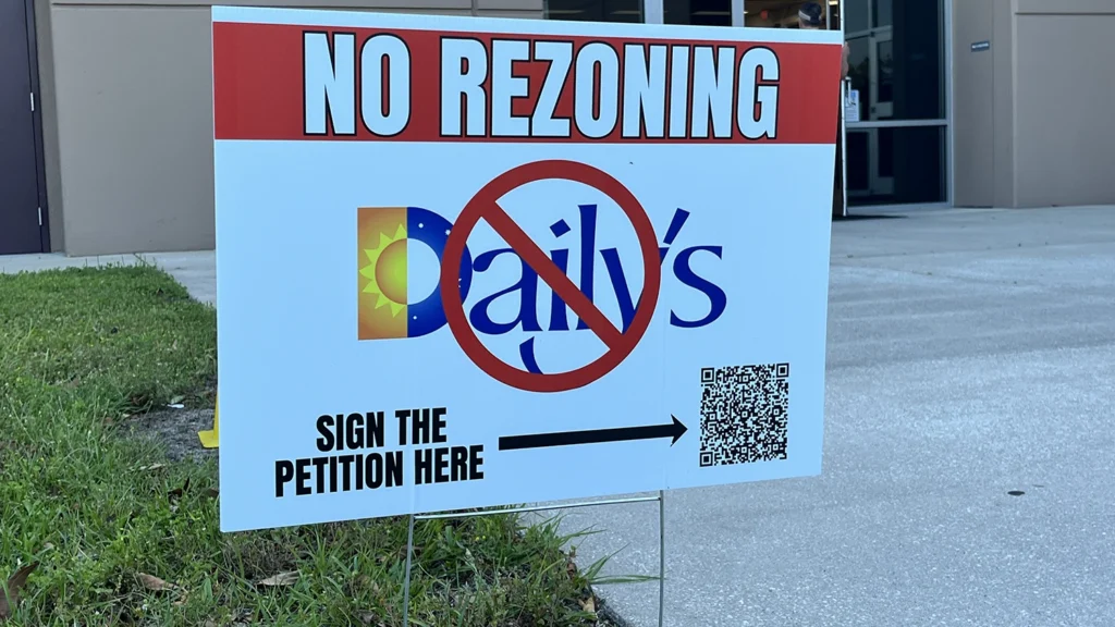 Signs outside of a community meeting in Fruit Cove illustrate many residents' feelings about a proposed Daily's on State Road 13.