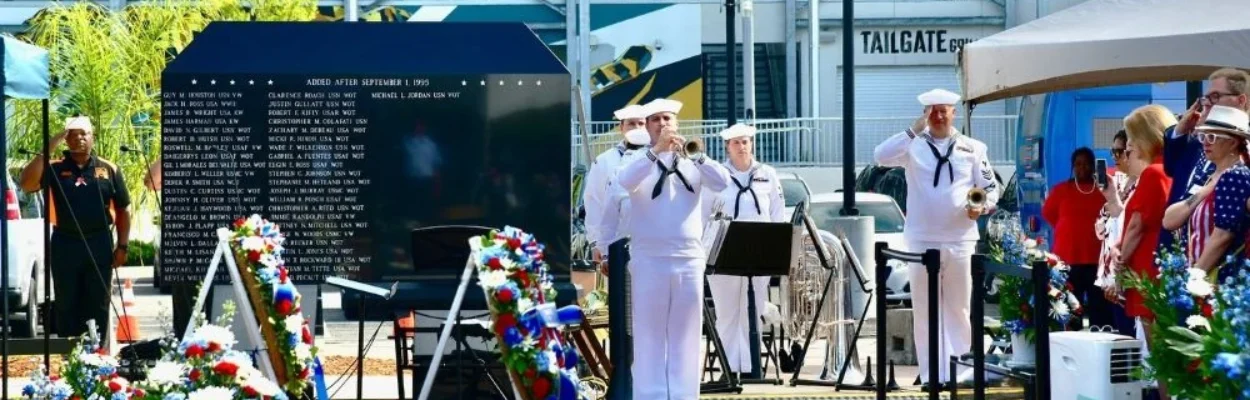 A member of the Navy Band Southeast plays taps during a Memorial Day observance at the Jacksonville Veterans Memorial Wall.