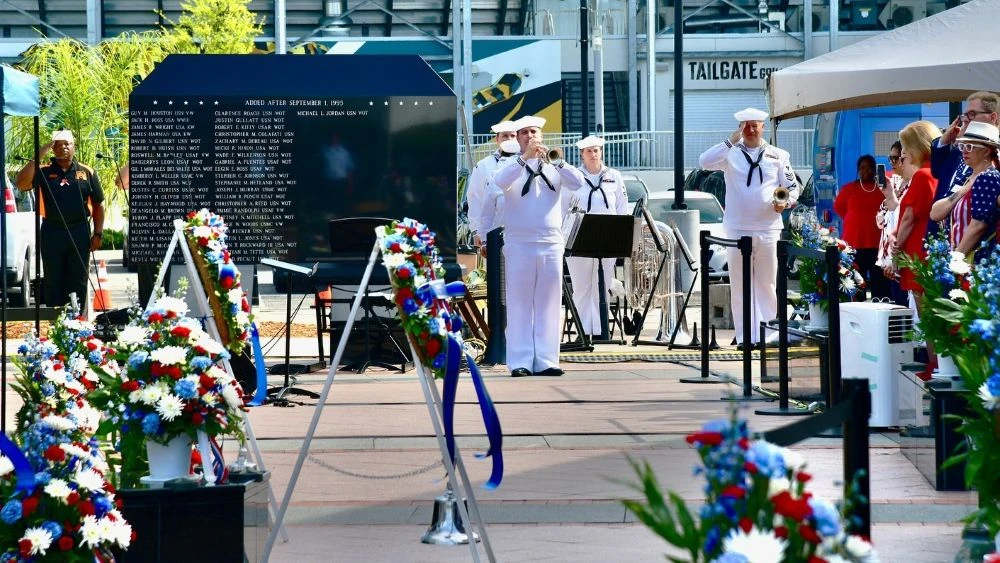 A member of the Navy Band Southeast plays taps during a Memorial Day observance at the Jacksonville Veterans Memorial Wall.
