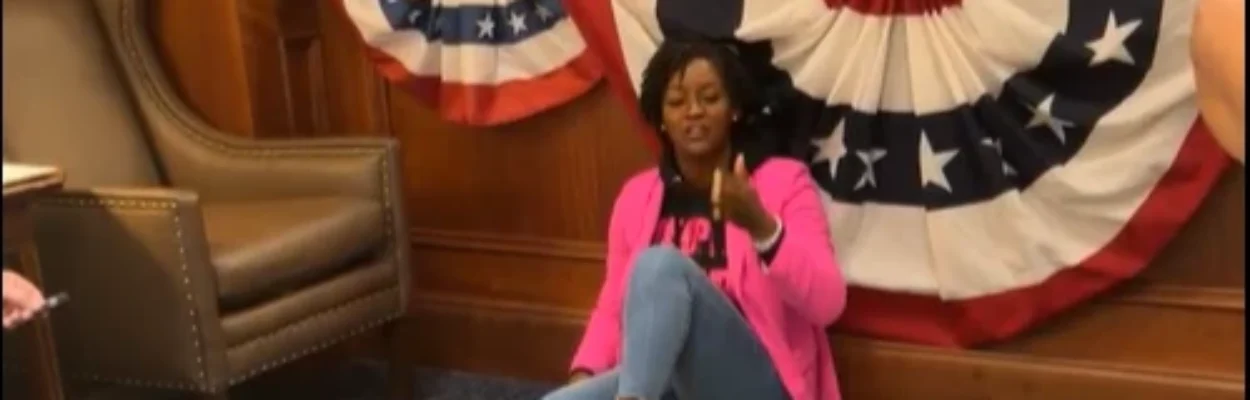 Rep. Angie Nixon sitting on the floor