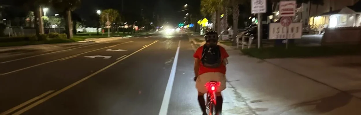 A cyclist rides at night in the bike lane of A1A Beach Boulevard. The local SUN Trail project will replace a sidewalk.
