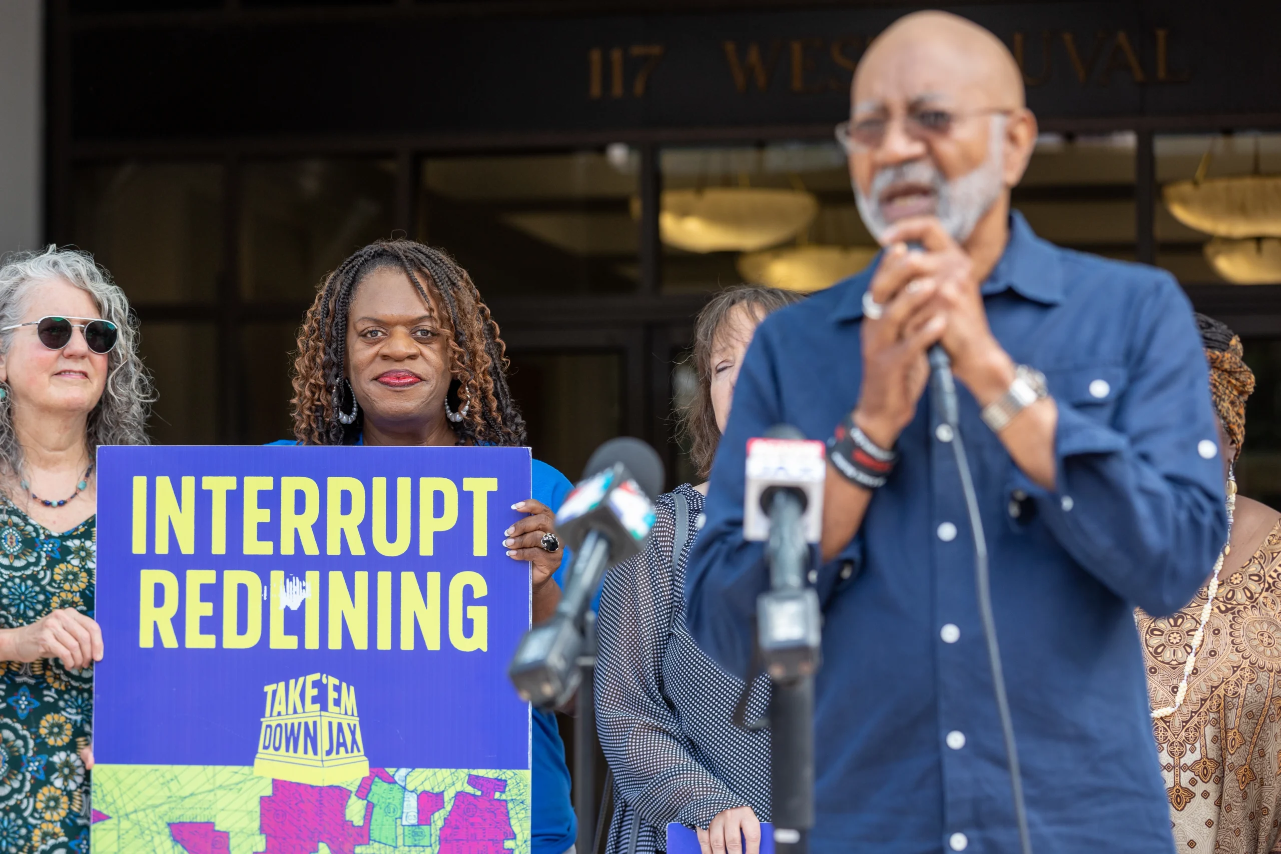 Activists protest potential jail sites in redlined neighborhoods.