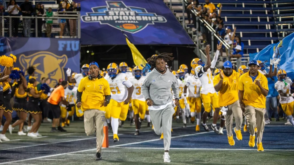 Head coach Teddy Bridgewater and Miami Northwestern take the field prior to a FHSAA Class 3A state final. Raines lost to Miami Northwestern 41-0 in a FHSAA Class 3A state championship on Saturday, Dec. 14, 2024. | Will Brown, Jacksonville Today