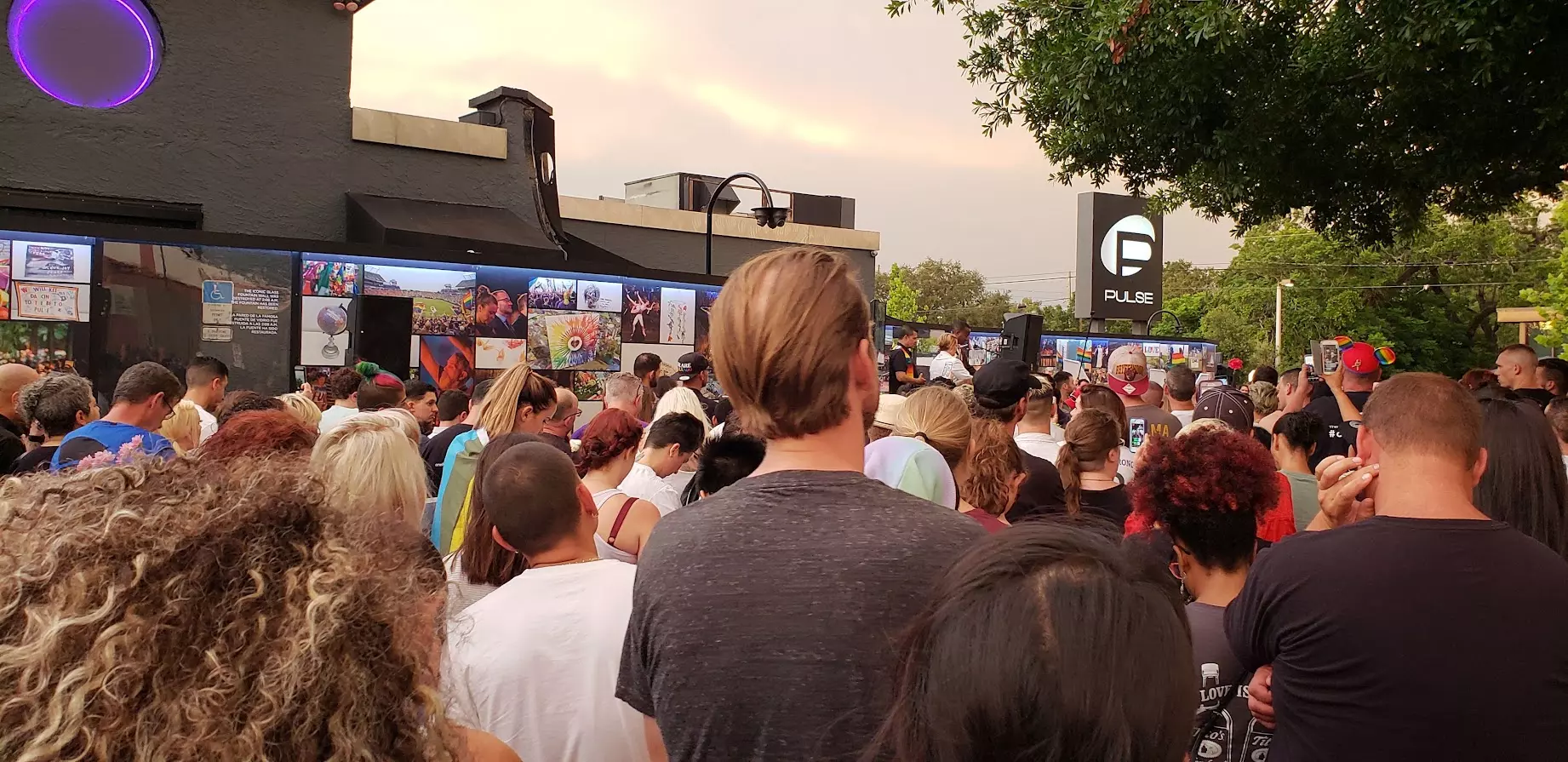 Hundreds gather to grieve on June 12, 2018, outside of the Pulse Nightclub. Ten years after the Pulse Nightclub shooting, the community remains changed both in ways of pain and grief, but also in embracing communities from around the region, experts say.