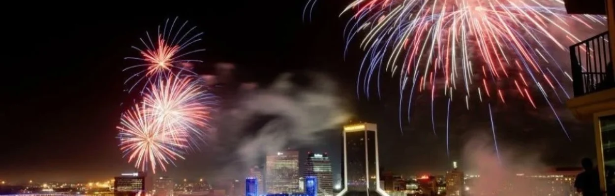 Fireworks explode in the sky over the Jacksonville skyline.