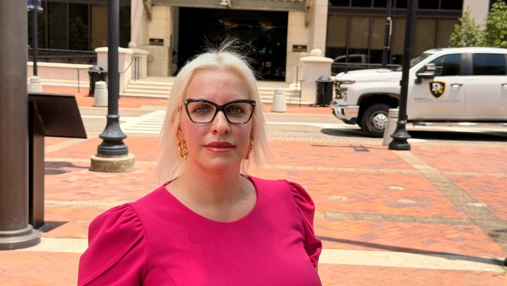 Libertarian Addison Patrick stands in front of Jacksonville City Hall.