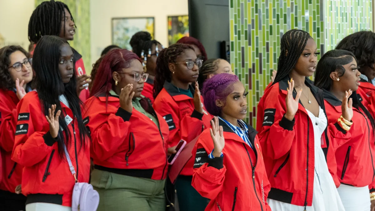 Success coaches in bright jackets stand to represent City Year Jacksonville