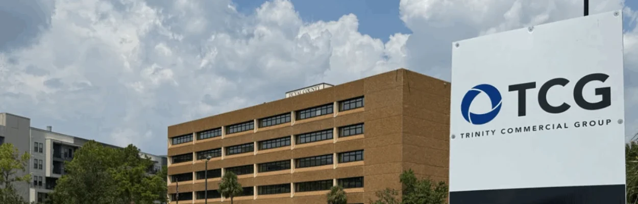 The Duval County Public Schools headquarters is shown in the background, with a TCG real estate sign in the foreground.