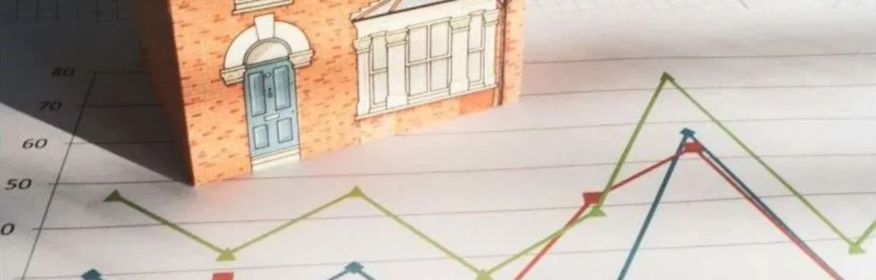 An illustration of a home and lines on a graf, indicating the trend in housing affordability.