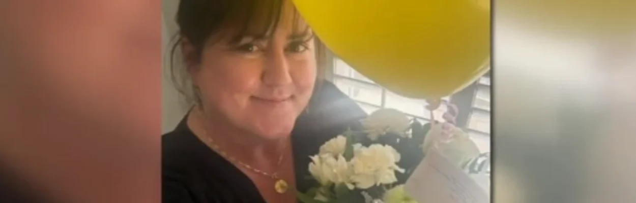 Former Trout Creek Academy Principal Katherine O'Connell smiles with flowers she received from rapper Fetty Wap
