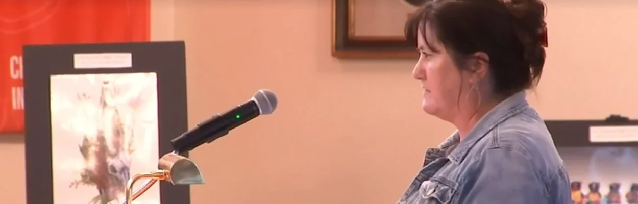 Trout Creek Academy Principal Katie O’Connell speaks at a microphone.