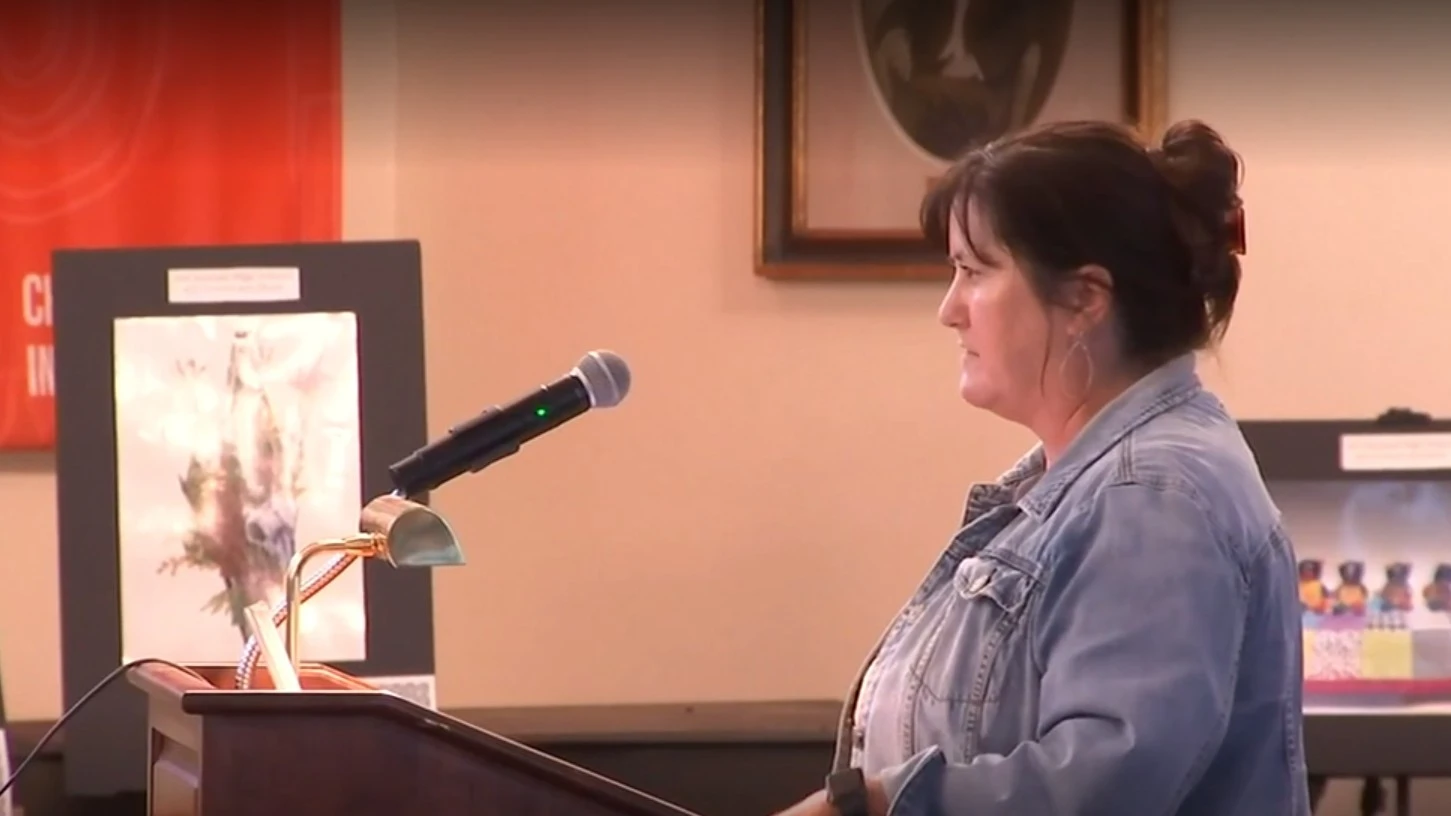 Trout Creek Academy Principal Katie O’Connell speaks at a microphone.