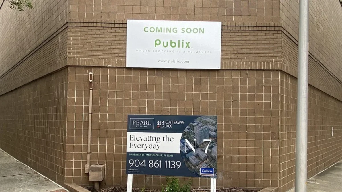 A sign on a building announces that Publix is coming soon.