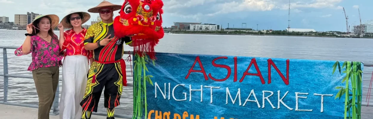 People standing next to Asian Night Market sign with dragon head