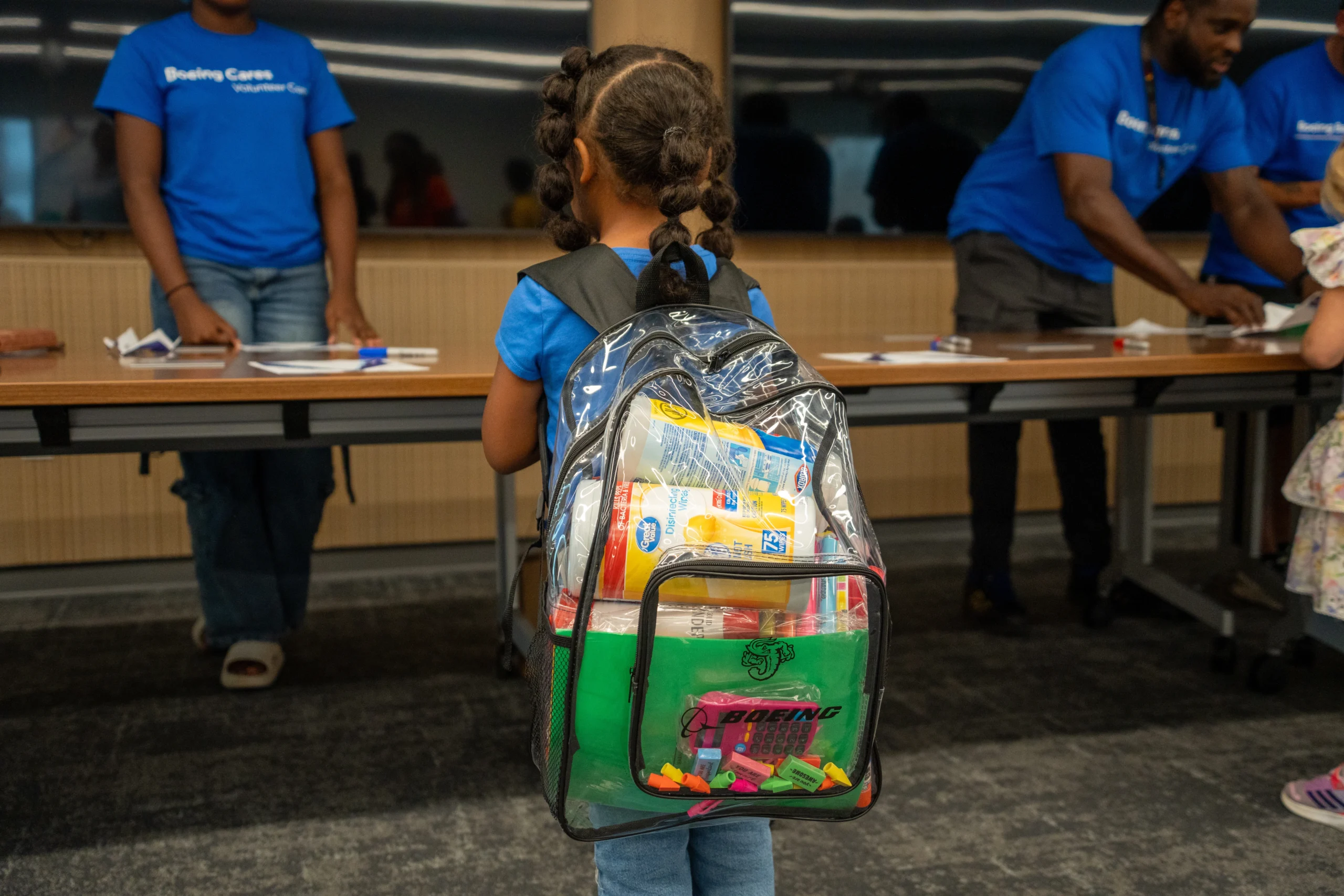 A student wears a backpack stuffed with supplies at the Boeing Jacksonville Back to School Giveaway.