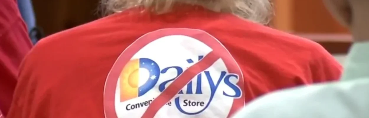 A resident wears a red shirt with a circle and slash through a Daily's logo.