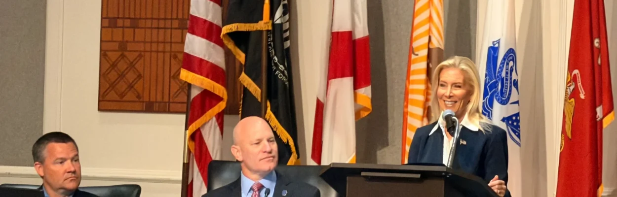 Jacksonville Mayor Donna Deegan standing at a lectern with City Council President Nick Howland to her side.