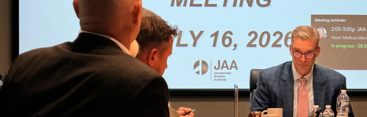 JAA Board Chair David Hodges Jr. sits at a table leading a meeting about a lawsuit against the city of Jacksonville.