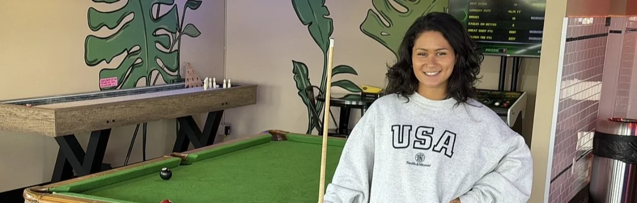 Cianna Bommarito, co-owner of Kava & Co., stands near a pool table inside the business.