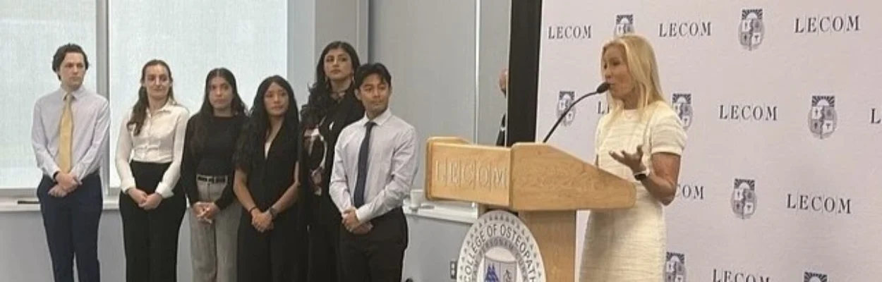 Mayor Donna Deegan stands on a podium addressing the audience at Jacksonville's first medical school.