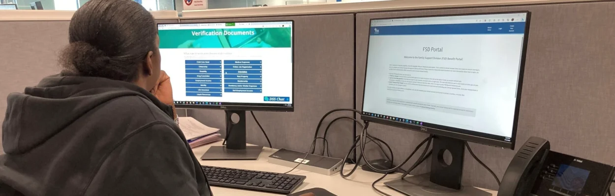 A man sits at a computer terminal looking at a screen while looking for work.
