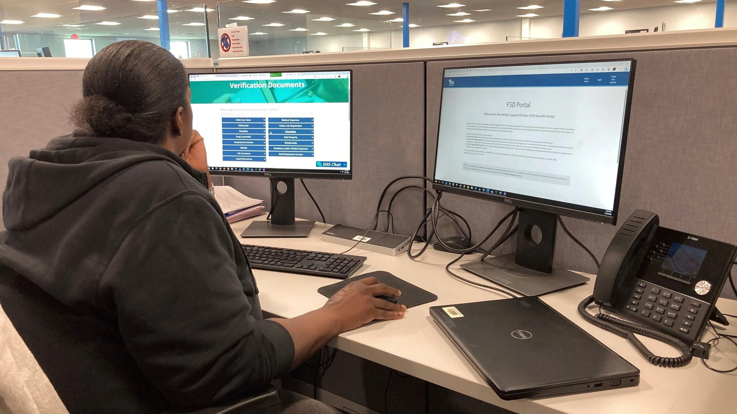 A man sits at a computer terminal looking at a screen while looking for work.