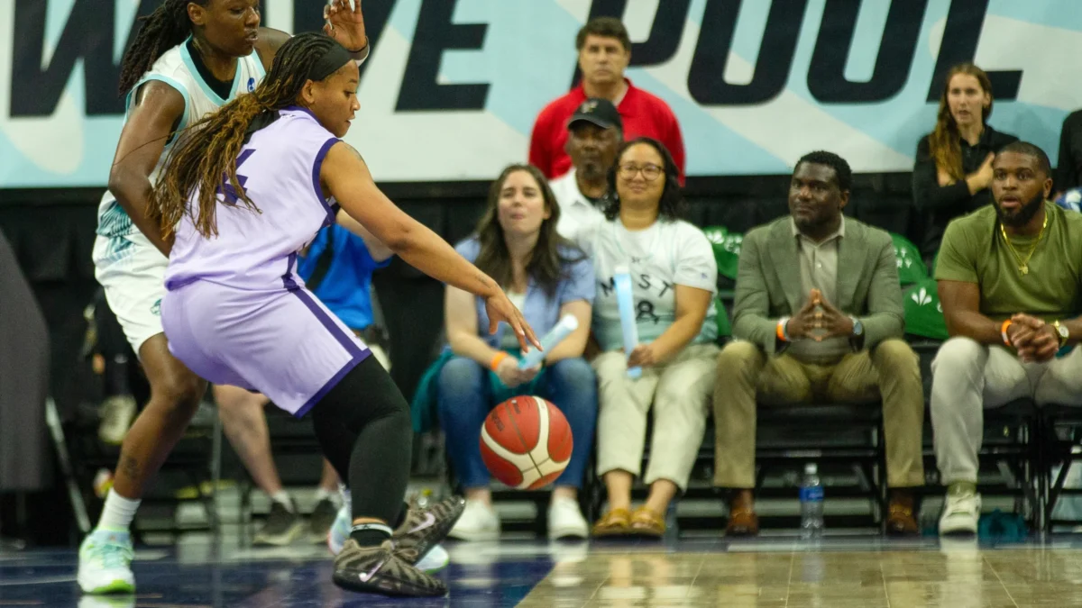Jasmyne Roberts, in purple, backs down Rennia Davis, in white, in an Upshot League basketball game.