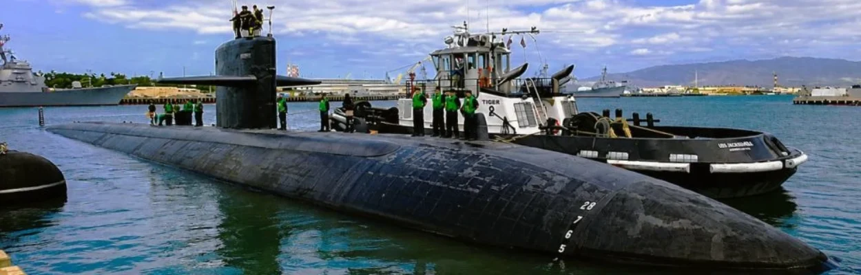 Sailors stand atop the USS Jacksonville submarine.