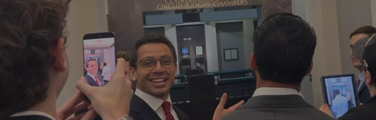 James Fishback smiles as supporters and members of the media record him outside the courtroom following a hearing at the Leon County Courthouse in Tallahassee.