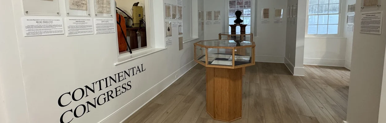 A hallway in the Karpeles Manuscript Museum with exhibits on the wall pertaining to the country's founding.