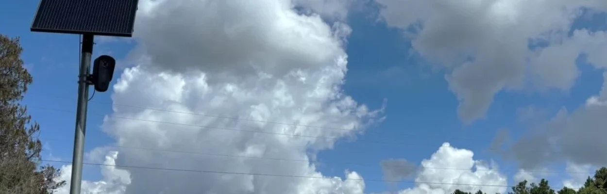 A Flock camera is shown along a road in Putnam County, with traffic passing by.