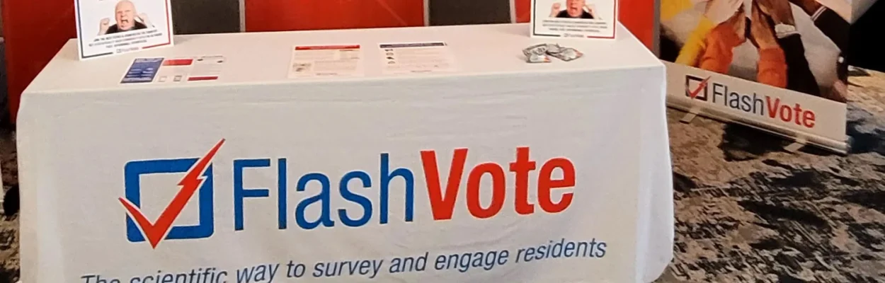 FlashVote advertised on a tablecloth at a conference