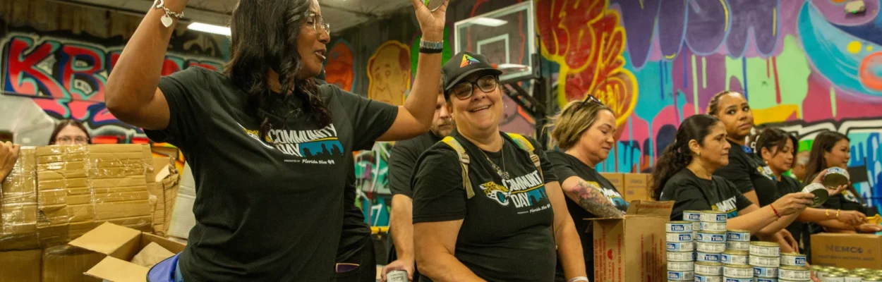 food bank volunteers pack apple sauce containers