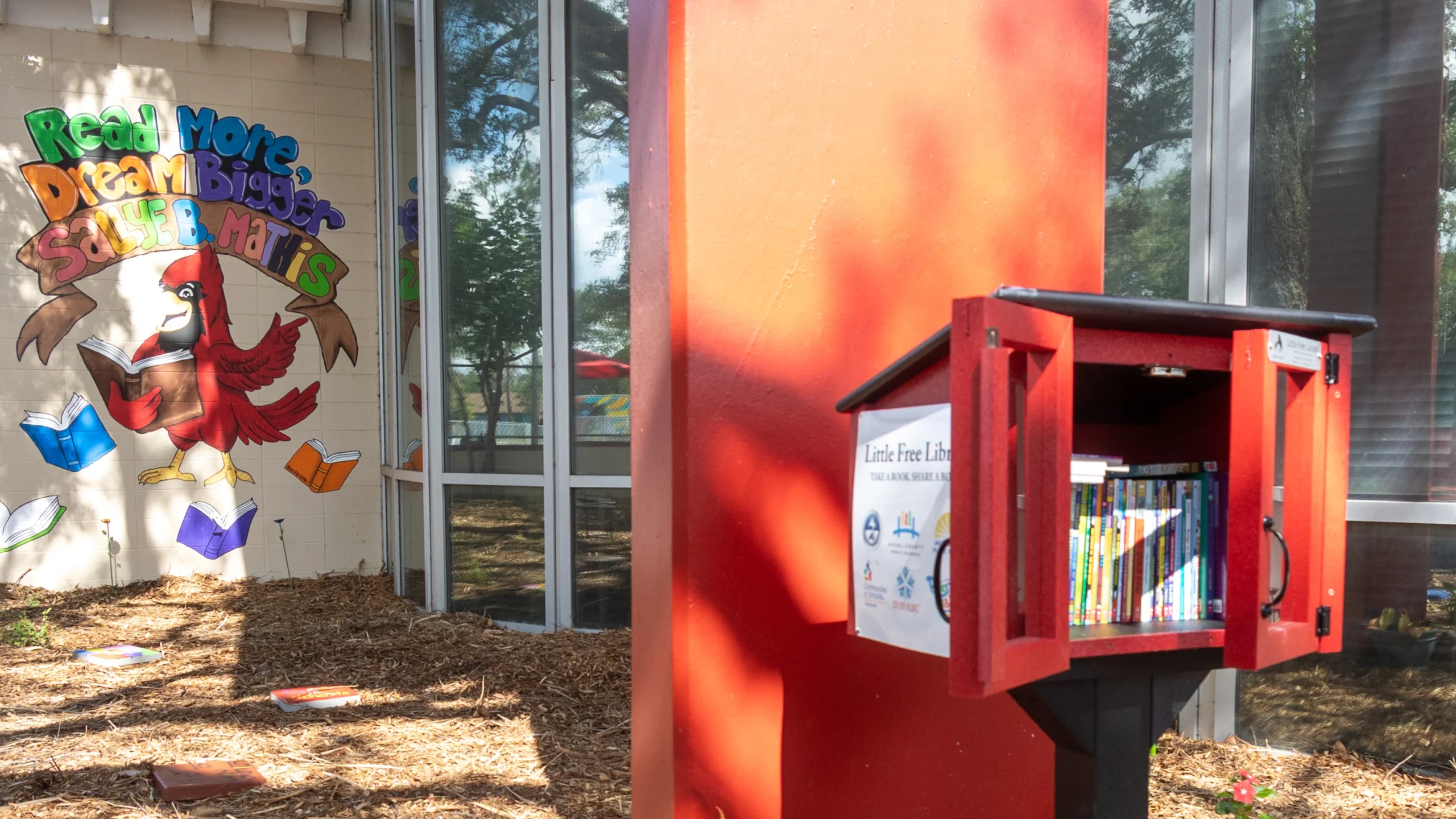 Attempting to increase literacy, a red box contains a Little Free Library at Sallye B. Mathis Elementary in Northwest Jacksonville.